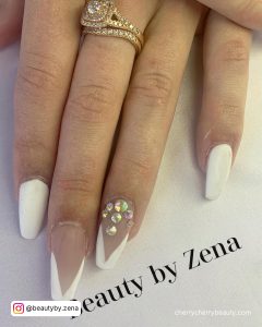 White Matte Nails With Design Paired With Diamonds On Ring Finger