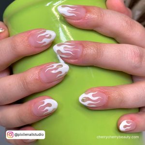 White Nails With Flame On A Green Surface