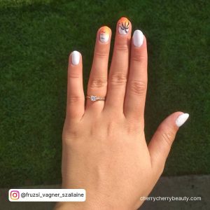 White Nails With Orange Design On Two Fingers