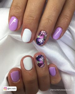 White Nails With Purple Flowers On One Finger
