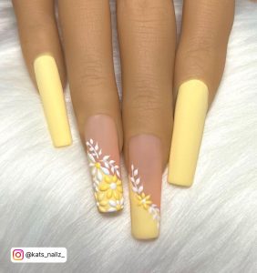 White Nails With Yellow Flowers On Two Nails