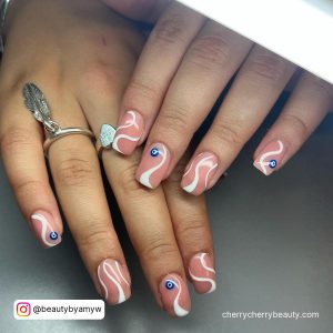 White Swirl Nail Designs Starting With A Blue Dot On Two Fingers