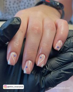 White Swirl Nail Designs With A Blue Dot