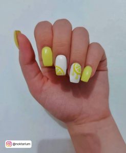 Yellow And White Acrylic Nails With Design On 2 Fingers
