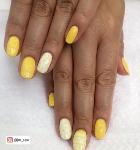 Yellow And White Nails With Unique Pattern On One Nail