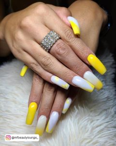 Yellow White Nail Designs On A Furry Surface
