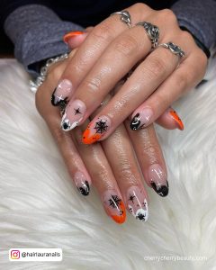Acrylic Halloween Nails With Black, White, And Orange Tips