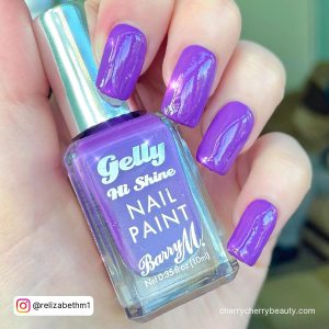 Acrylic Nails Light Purple Holding A Nail Polish