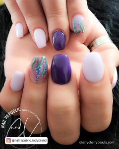 Acrylic Purple And White Nails With Design On One Finger