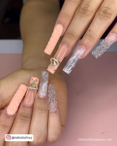 Acrylic Rose Gold Quinceanera Nails With Peach And Clear Nails