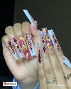 Acrylic White And Gold Nails With Red Rhinestones