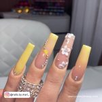 Acrylic Yellow Nails With Diamonds And Flowers
