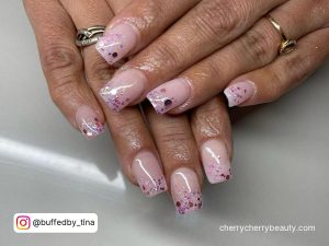 Adorable Pink Glitter Acrylic Nails Over White Surface