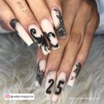 Birthday Acrylic Nails With Nude Base Coat And Black Design