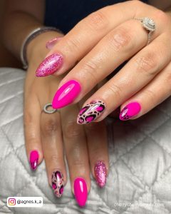 Bright Pink Glitter Acrylic Nails With Spot Pattern On Ring Finger