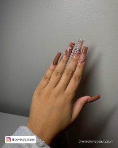 Brown Square Acrylic Nails With Design On 3 Fingers