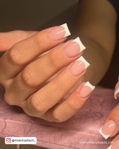 Chic French Tip Square Acrylic Nails Over Pink Surface