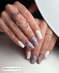 Chic Short Christmas Acrylic Nail Ideas With Leaf Designs And Line Work On White Surface