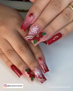 Christmas-Themed Red Acrylic Nails Designs On White Surface