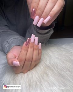 Chrome Pink Nail Polish On One Finger