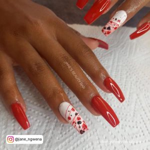 Coffin White And Red Heart Acrylic Nails On White Surface