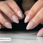 Cute Beige Acrylic Christmas Nails With Heart Design On White Surface