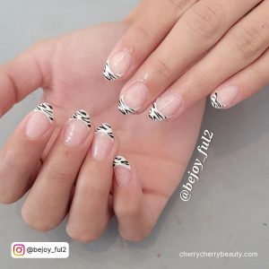 Cute French Tip Acrylic Nails With Zebra Print Over White Surface