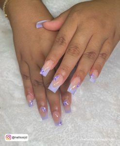 Cute Lilac French Acrylic Nail Designs With Flowers Over White Towel