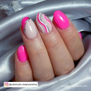 Cute Pink Summer Acrylic Nails With Glitter And Swirly Design Wrapped Between Silver Clothe