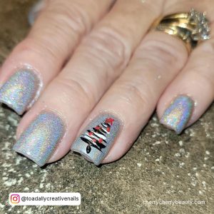 Cute Short Glitter Acrylic Nails With White, Black, And Red Design Over Shimmery Surface