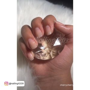 Cute Simple Fall Acrylic Nails Holding Rugby Over White Fur