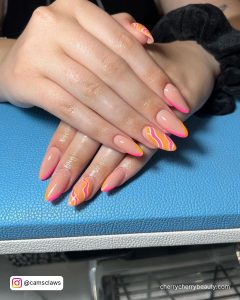 Cute Summer Acrylic Nail Ideas With Swirls And Outlined Tips Over Blue Surface