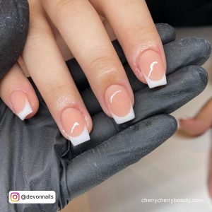 Easy Natural French Tip Acrylic Nails Held By Hands Wearing Black Gloves
