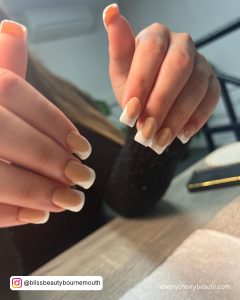 Flare French Nails Acrylic Designs With Wooden Table In Background