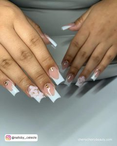 Flowery Short Square Acrylic Nails French Top Design With Stones Over White Surface