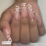 French Medium Square Acrylic Nails With Cheetah Prints Over White Surface