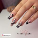 French Summer Acrylic Nail Ideas With Snake Drawing And Stones Over White Surface