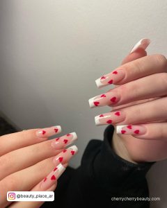 French Tip Acrylic Nails For Christmas With White Wall In Background