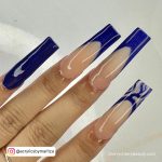 Glossy Blue French Tip Acrylic Nails Over White Background