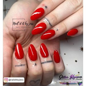 Glossy Red Oval Acrylic Nails Over White Surface