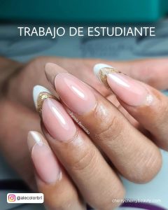 Layered Acrylic Oval French Tip Nails With Goiters And Beige Color Over White Surface