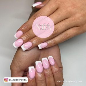 Light Pink French Tip Acrylic Nails Over White Surface