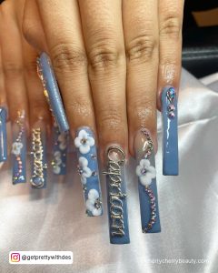 Long Acrylic Birthday Nails In Blue With White Flowers