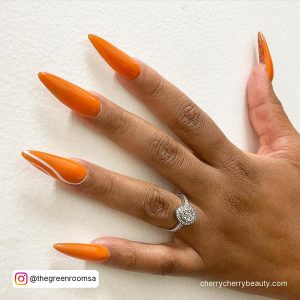 Long Orange Summer Almond Acrylic Nails On White Surface