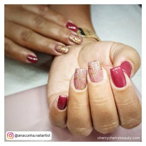 Long Pink Square Acrylic Nails With Golden Design On One Finger