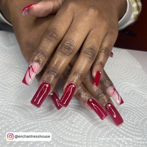 Long Red Square Acrylic Nails With Diamonds On White Surface