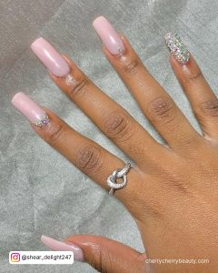 Long Square Pink Nails With Glitter On One Finger