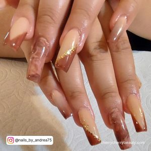 Marble Fall Coffin Acrylic Nails With Gold Flakes Over White Surface