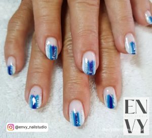Multi-Shade /Blue Short Acrylic Nails With Glitters On White Towel