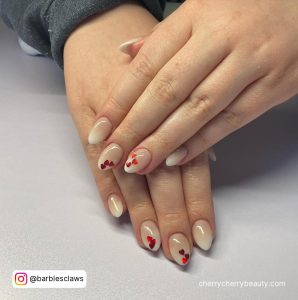 Ombre Almond Natural Short Acrylic Nails With Red Hearts Over White Surface